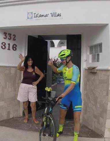 IslaMar Villas property entrance with Hostess Andrea & Ironman Competitor — In Town Villas, Cozumel
